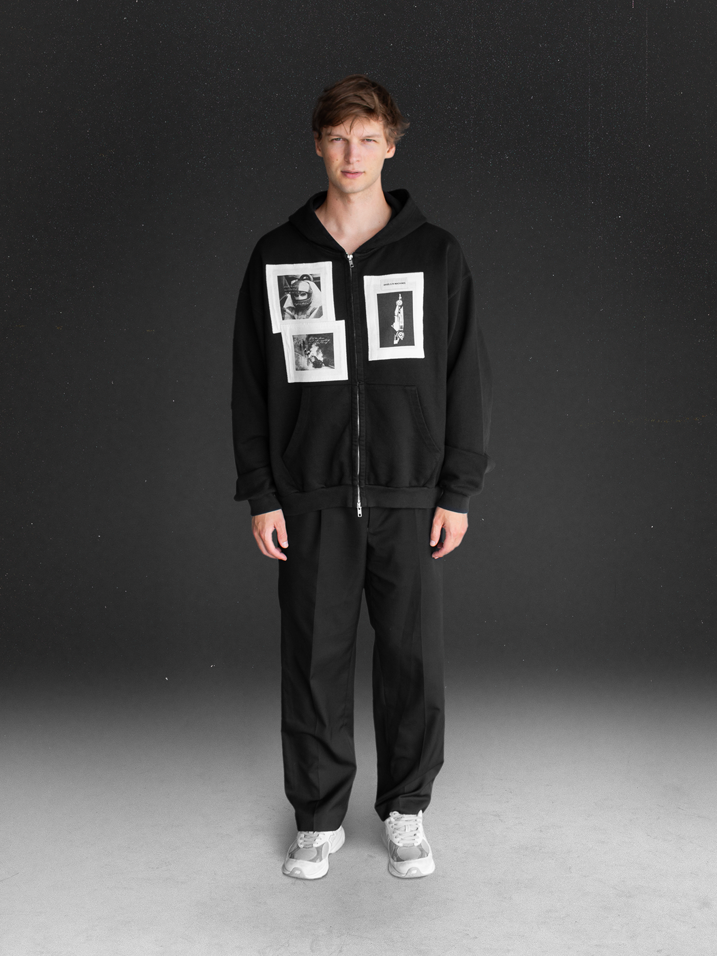 Wearing a Angels in Mahines black zip-up with printed Formula 1 images